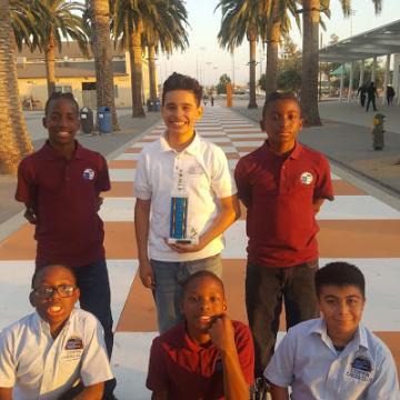 Luis (center) middle school chess champion